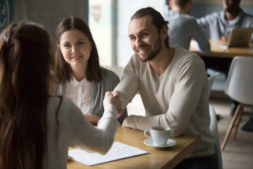 happy couple paying landlord